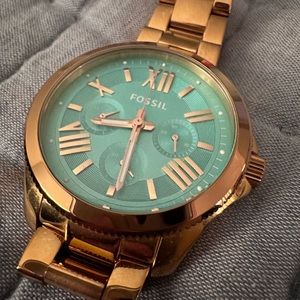 Rose gold fossil watch with turquoise face